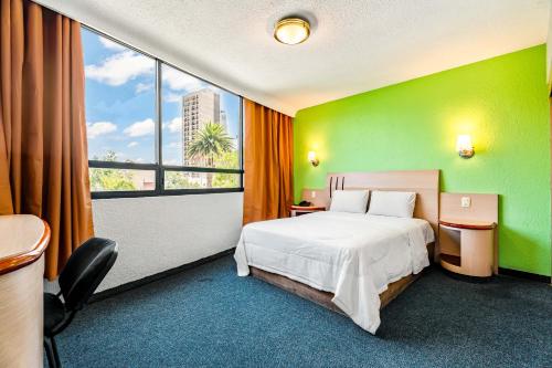 a hotel room with a bed and a large window at Hotel Arizona in Mexico City