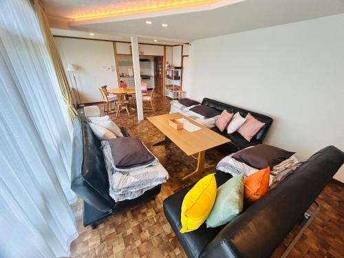 a living room with a couch and a table at Higashikawa home in Higashikawa