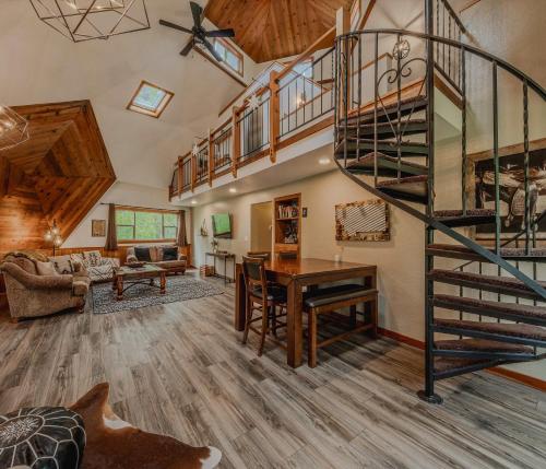 a living room with a spiral staircase in a house at Gateway to Glacier in Columbia Falls