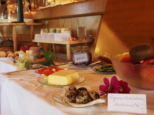 a table with cheese and other food on it at Gasthof Pesbichl in Goldegg