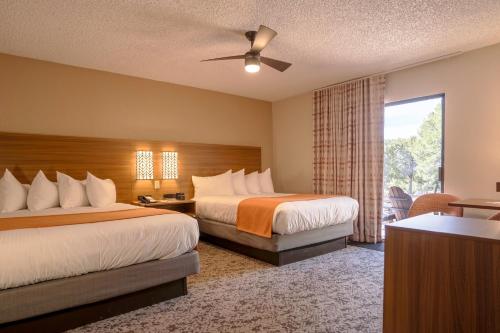 a hotel room with two beds and a window at Maswik Lodge - Inside the Park in Grand Canyon Village