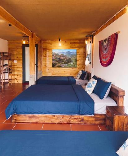 a bedroom with a bed in a log cabin at Ap Retreat - Ta Van's Heel in Sapa