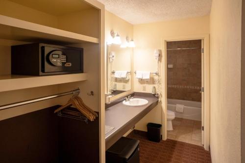 a bathroom with a sink and a microwave at Maswik Lodge - Inside the Park in Grand Canyon Village