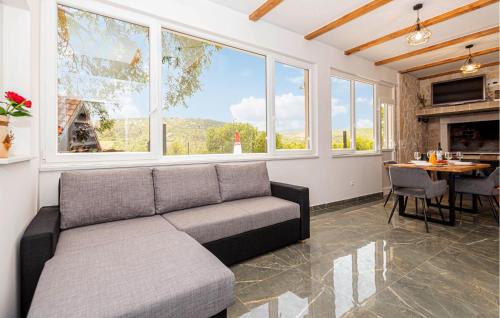a living room with a couch and a table at Gorgeous Home In Primosten in Primošten