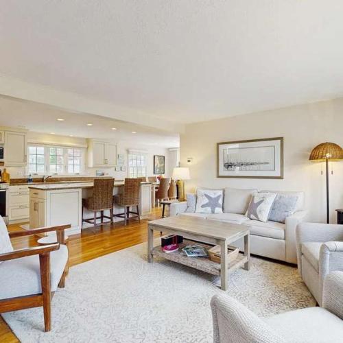 a living room with a couch and a table at Harborside Retreat in Falmouth