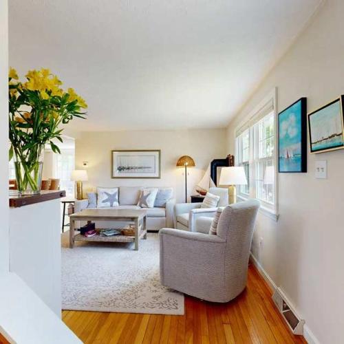 a living room with a couch and a table at Harborside Retreat in Falmouth