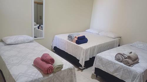 a bedroom with two beds with towels on them at Studio Figueira, Casa in Santarém