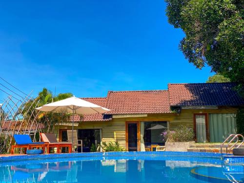 a house with a swimming pool in front of it at Solivo Ecolodge Phu Quoc in Phú Quốc