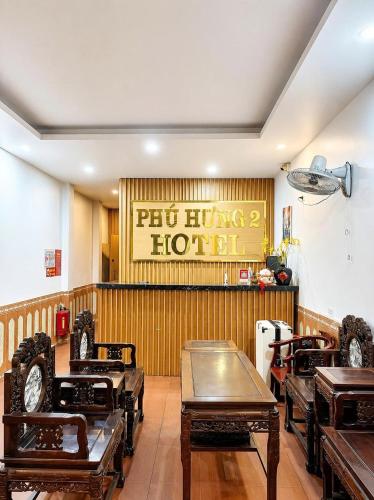 a restaurant with tables and chairs in a room at Khách Sạn Phú Hưng 2 in Hanoi