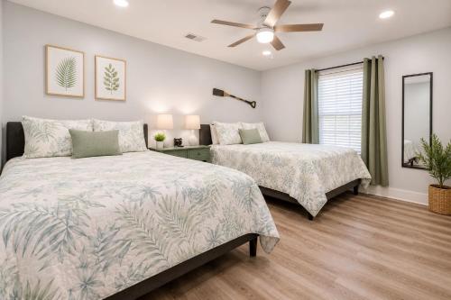 a bedroom with two beds and a ceiling fan at Heated Pool & Spa, 4min Walk To Beach - Zula Beach in Destin