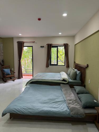 a large bedroom with two beds with pillows at LENA Home in Da Lat