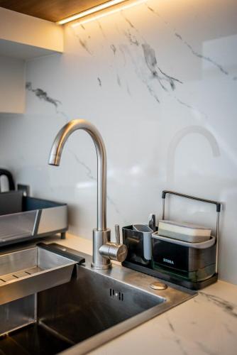 a kitchen with a sink and a counter top at Horizon Apartment with Ocean View in Cemagi