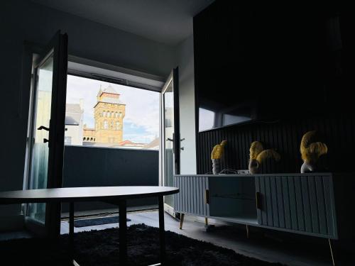 a room with a table and a view of a building at Modern 2 BR 2 Bath Flat With Balcony & Fast WiFi in Cardiff