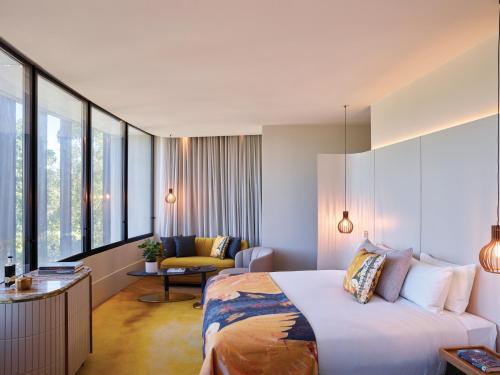 a hotel room with a bed and a living room at Crystalbrook Kingsley in Newcastle