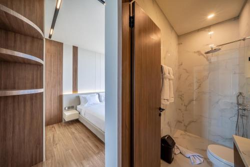 a bathroom with a bed and a shower and a toilet at Horizon Cemagi 2BR with Ocean View in Cemagi