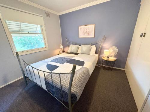 a bedroom with a bed and a window at Horace Street 8 in Shoal Bay