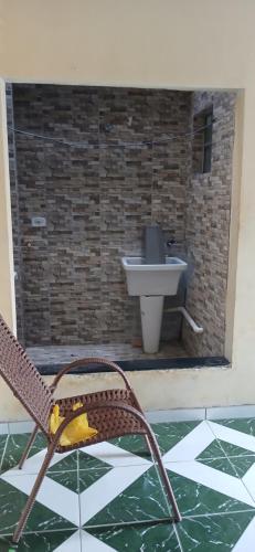 a bathroom with a sink and a chair at Lazer do DUELÃO in Pão de Açúcar