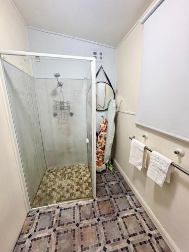 a shower with a glass door in a bathroom at Horace Street 8 in Shoal Bay