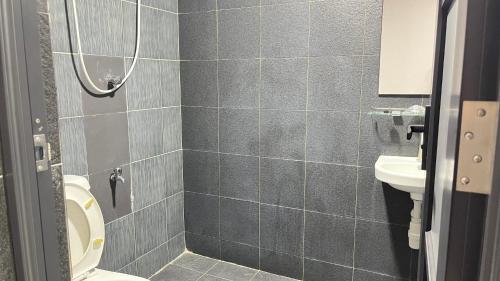 a bathroom with a toilet and a sink at Winnieys Boutique Hotel in Kuala Lumpur