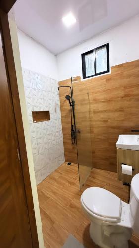 a bathroom with a shower and a toilet and a sink at River View-Camping Add-On Available in Jarabacoa