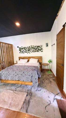 a bedroom with a large bed in a room at River View-Camping Add-On Available in Jarabacoa