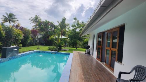 a swimming pool in the backyard of a house at Haven Retreat in Pacific Harbour