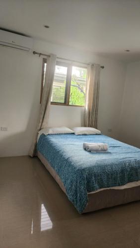 a bedroom with a bed with two towels on it at Haven Retreat in Pacific Harbour