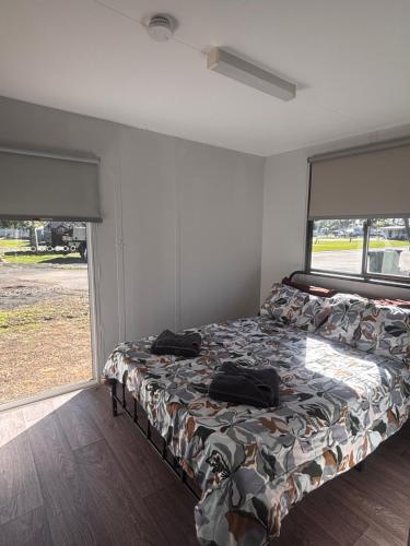 a bedroom with a bed in a room with a window at Pioneer Caravan Park in Dalby