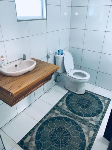 a bathroom with a toilet and a sink at Bulan Bungalows and Cafe in Tetebatu