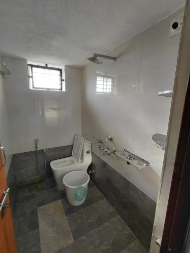 a bathroom with a toilet and a sink at AGM Spacious Private AC 1BHK with Hall, Kitchen & Bath in Udupi