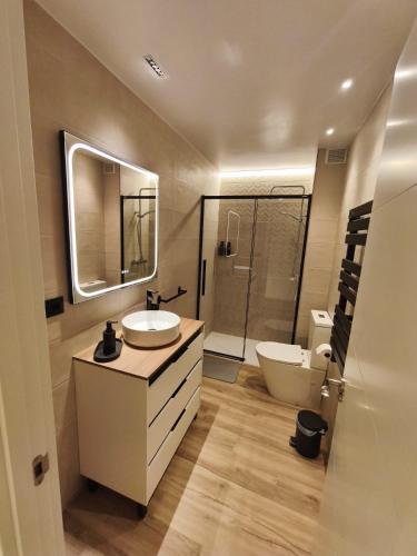 a bathroom with a sink and a toilet and a mirror at Casa Juanito Rute in Rute