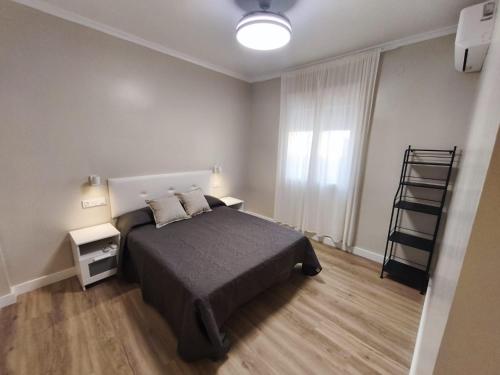 a bedroom with a bed and a ladder in it at Casa Juanito Rute in Rute