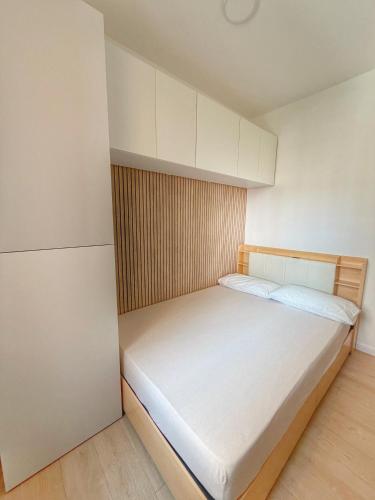 a small bedroom with a large bed in it at HOME PERLa in San Bartolomeo al Mare