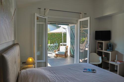 a bedroom with a bed and a patio with an umbrella at Chambre d'hôtes Ganttipienea in Ahetze