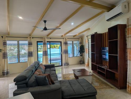 a living room with a couch and a table at Panatina Hillside 2 bedroom apartment in Honiara