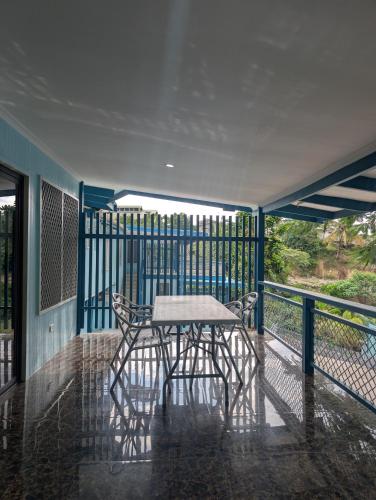 a table and two chairs on a balcony at Panatina Hillside 2 bedroom apartment in Honiara