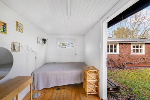 a bedroom with a bed in a white room at Cozy Holiday Home Close To Forest And Beach in Hasle