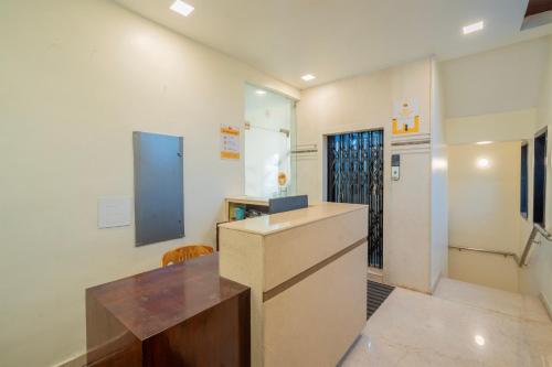 a kitchen with a counter and a refrigerator at Itsy Hotels M in Vijayawāda