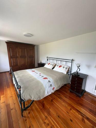 a bedroom with a bed and a wooden floor at La Ville CIR00002 in Allein