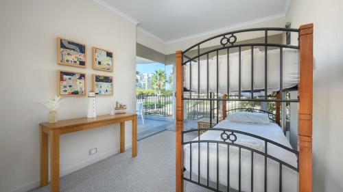 a bedroom with a bunk bed and a desk at Del Mar 1 in Mandurah
