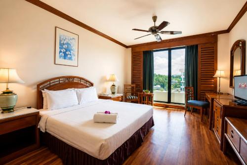 a hotel room with a bed and a television at Sabah Oriental Hotel in Kota Kinabalu
