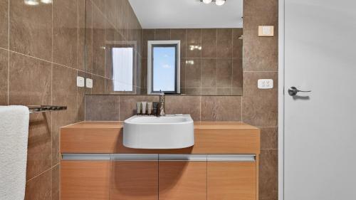 a bathroom with a sink and a mirror at Alpenglow in Dinner Plain