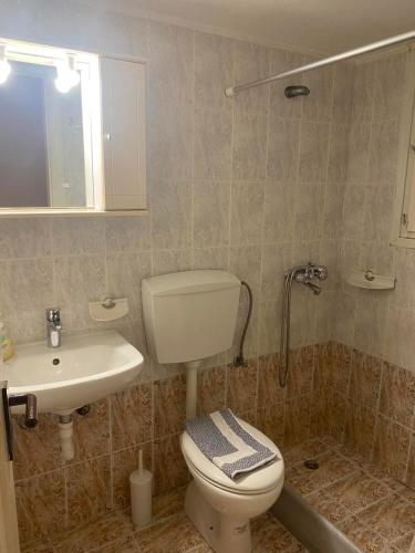 ein Badezimmer mit Toilette und Waschbecken in der Unterkunft Studios Anna in Lipsi