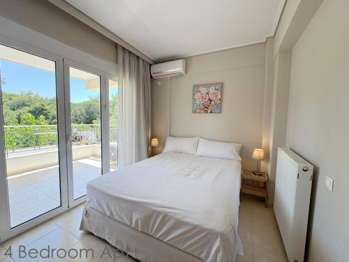 a bedroom with a bed and a balcony at Schinias Forest Beach House in Marathon