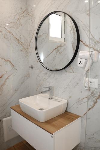 a bathroom with a sink and a mirror at Hotel Alga Velipoje in Velipojë