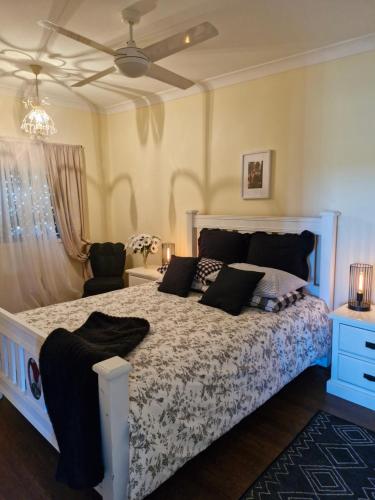 a bedroom with a bed with a blue and white comforter at Vibrant & Vintage B & B in Greenmount