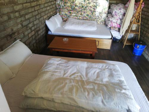 a bed in a room with a couch and a table at Syangbo Homestay in Nagarkot