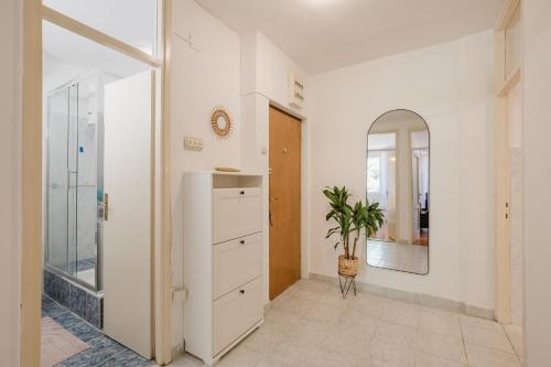 a room with a white refrigerator and a potted plant at Mila in Herceg-Novi