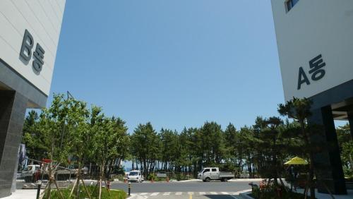 a parking lot in front of a building at Sokcho Ocean Beach in Sokcho