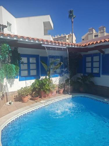 a swimming pool in front of a house at Beautiful Holiday Villa with heated private pool, Los Cristianos in Los Cristianos